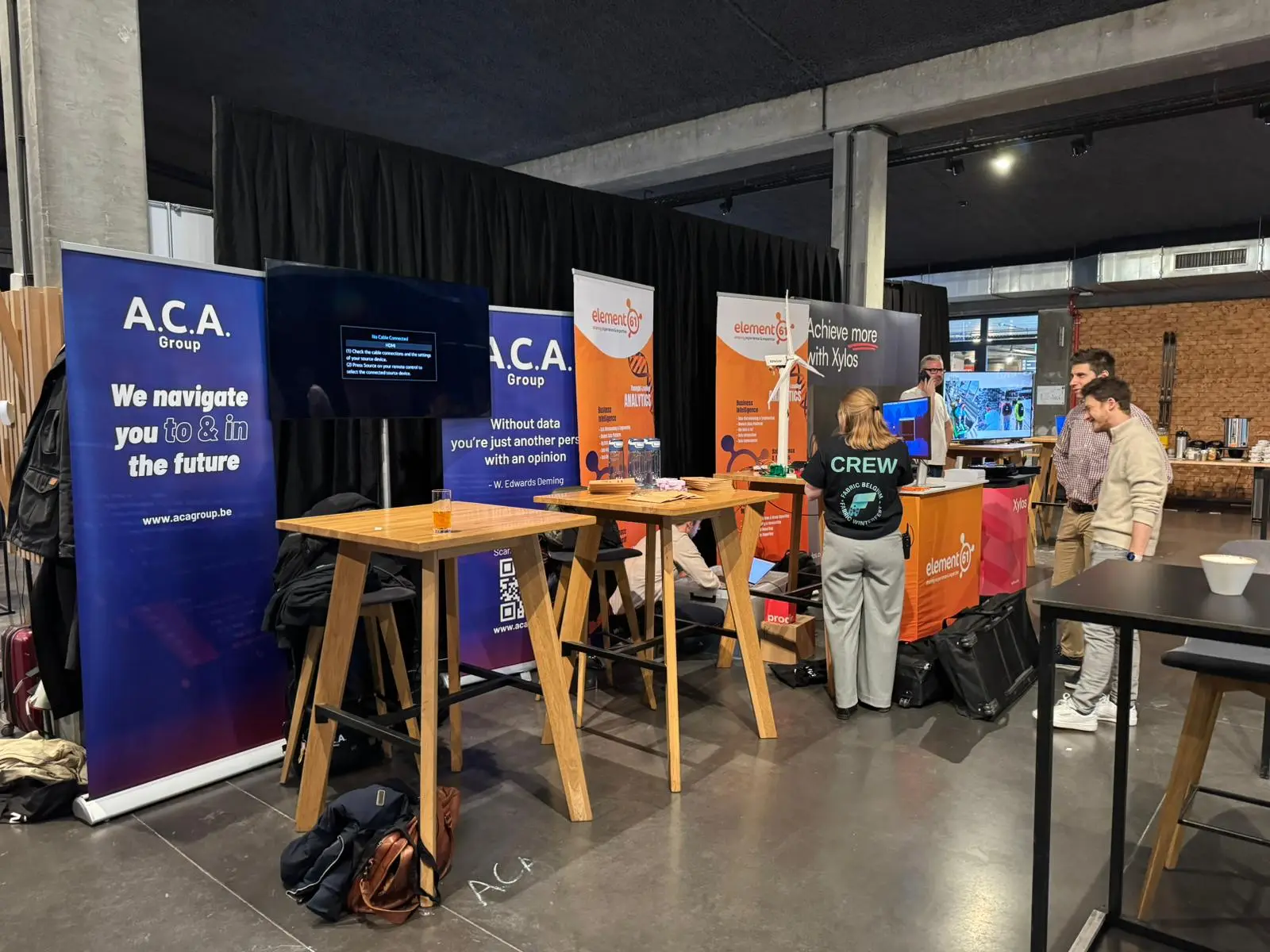 Attendees at the ACA Group stand on the expo floor