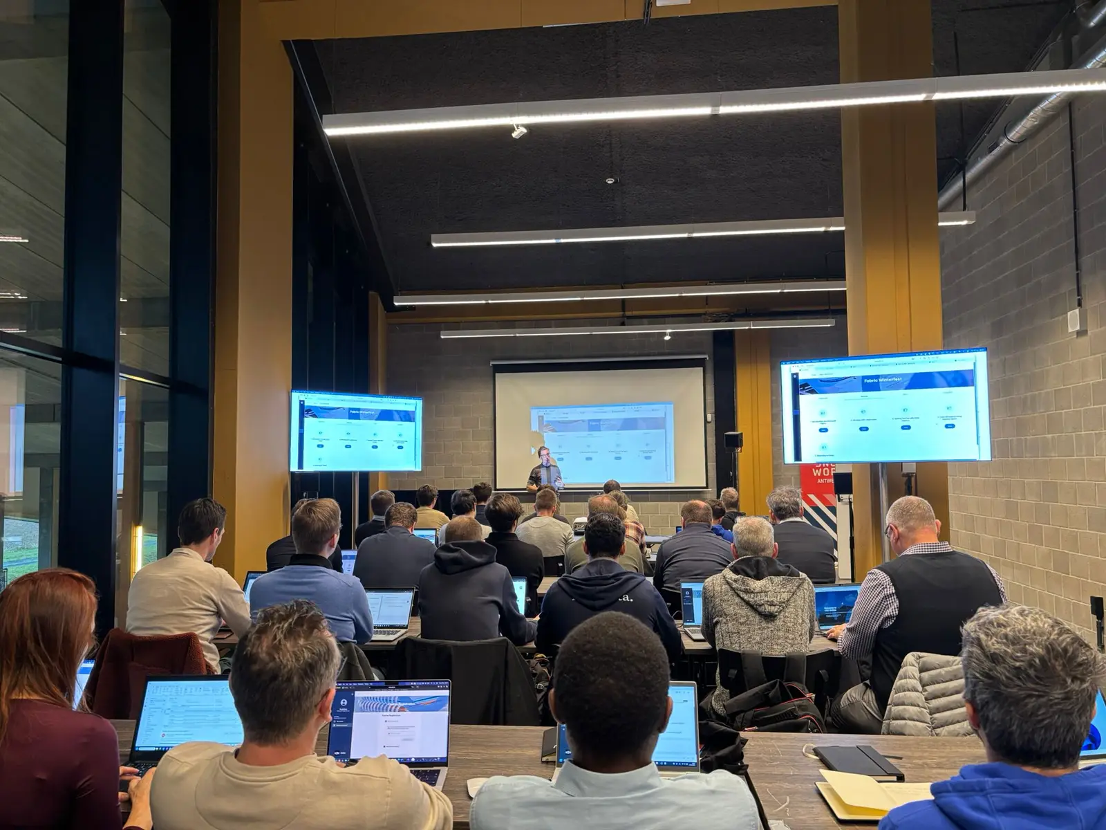 Attendees following a session on their laptops